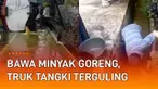 Sebuah insiden truk tangki membawa minyak goreng terguling di jalan mengundang perhatian.