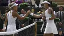Garbine Muguruza (kanan) bersalaman dengan Angelique Kerber usai laga hari ketujuh tunggal putri di Wimbledon Tennis Championships, London, (10/7/2017). Garbine menang 4-6, 6-4, 6-4. (AP/Tim Ireland)