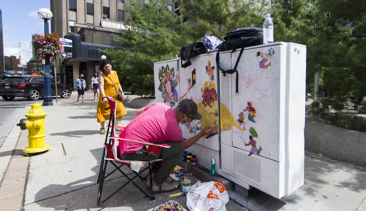 Seniman mengerjakan muralnya dalam acara Yorkville Murals 2020 di Toronto, Kanada (29/8/2020). Dengan karya mural artistik dan implementasi aktivasi budaya, acara tahunan ini dimulai Jumat (28/8) hingga Minggu (30/8) sebagai perayaan seni publik dan gerakan mural kontemporer. (Xinhua/Zou Zheng)