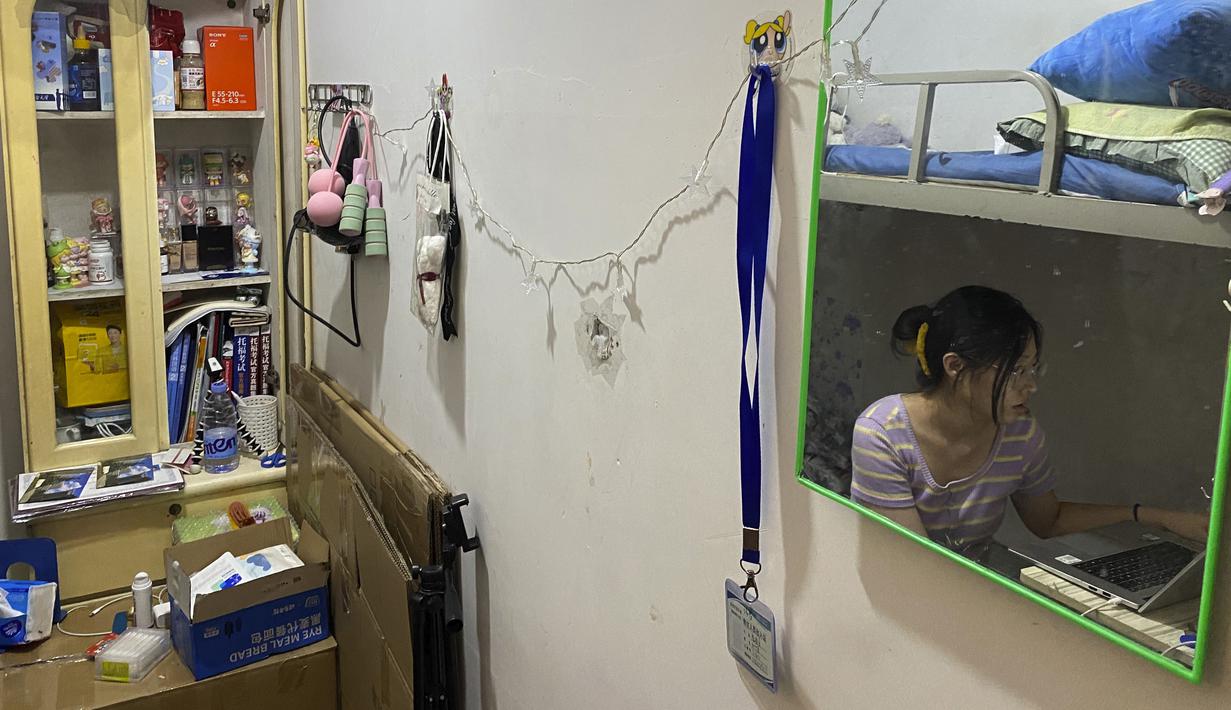 Lulusan perguruan tinggi baru-baru ini Liu Qian duduk di kamar yang dia sewa di sebuah apartemen di Beijing, Kamis, 7 Juli 2022. Liu adalah salah satu dari 11 juta lulusan baru yang putus asa untuk bekerja di pasar kerja yang suram karena lockdown COVID memaksa pabrik, restoran, dan pengusaha lainnya untuk tutup. Para penyintas memotong pekerjaan dan upah. (AP Photo/Olivia Zhang)