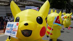 Aktivis lingkungan mengenakan kostum Pikachu saat berujuk rasa di depan kedutaan besar Jepang di Manila, Filipina, Selasa (25/6/2019). Para aktivis memprotes Jepang untuk menghentikan pembiayaan batu bara saat mereka bersiap untuk menjadi tuan rumah KTT G20. (AF Photo/Aaron Favila)