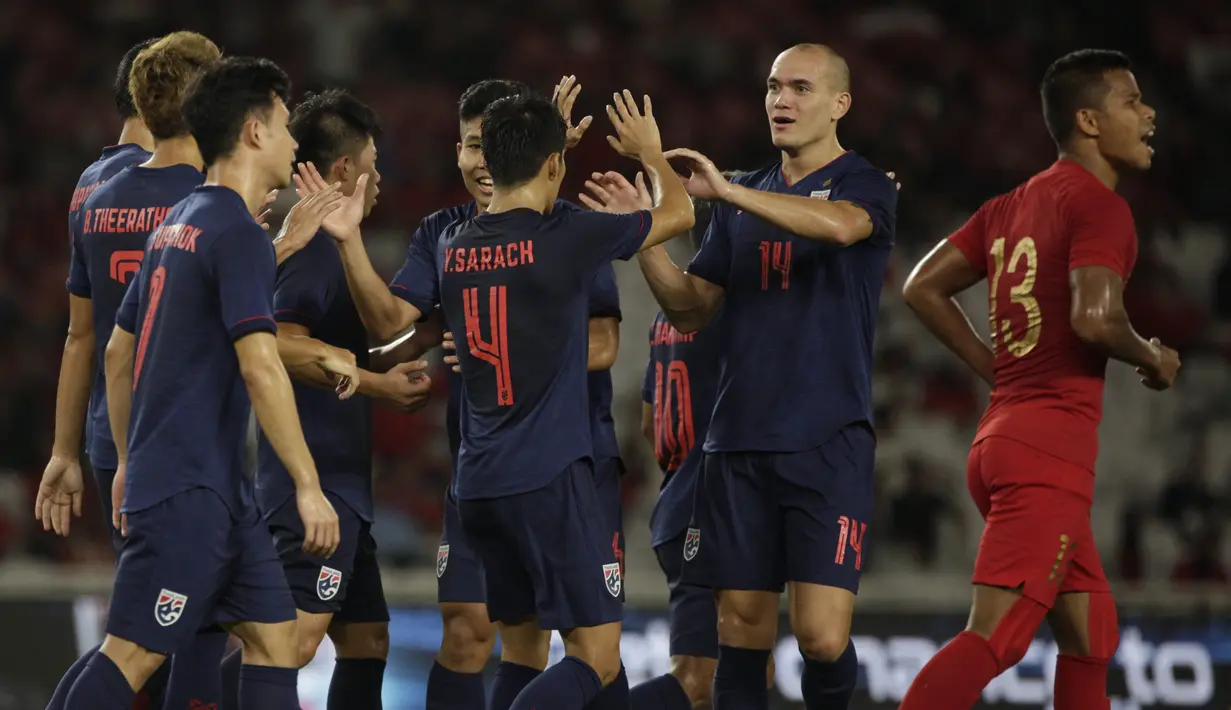 Para pemain Thailand merayakan gol yang dicetak Theerathon Bunmathan ke gawang Timnas Indonesia pada laga Kualifikasi Piala Dunia 2022 di SUGBK, Jakarta, Selasa (10/9). Indonesia kalah 0-3 dari Thailand. (AFP/Vitalis Yogi Trisna)