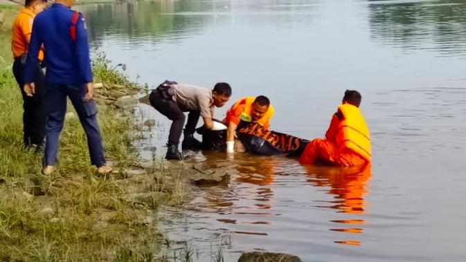 Petugas mengevakuasi jenazah Suhartini dari Sungai Siak, Pekanbaru. (Liputan6.com/M Syukur)