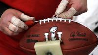 Pekerja mengikat bola American Football yang akan digunakan untuk NFL Super Bowl LI di pabrik di Wilson Sporting Goods di  Ada, Ohio, AS (23/1). (AP Photo/Charles Rex Arbogast)