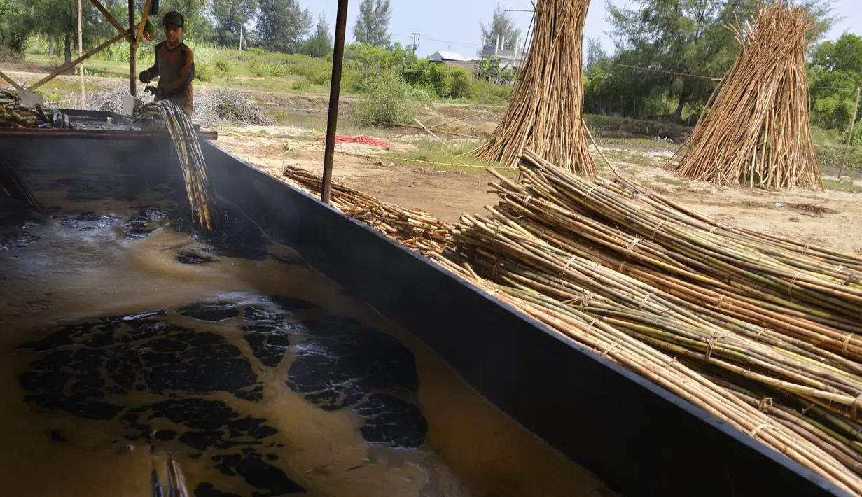 Seorang pekerja memasak rotan untuk diekspor di sebuah bengkel di Banda Aceh (16/10/2019). Setiap tahunnya, 	Aceh mampu memproduksi sekitar ratusan ribu ton rotan. (AFP Photo/Chaideer Mahyuddin)