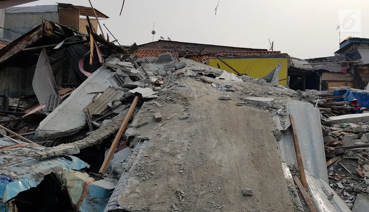 Suasana rumah roboh di  Jalan Pulo, Tanah Tinggi, Johar Baru, Jakarta Pusa, Jumat (26/4). Enam orang masih terjebak dan tengah dalam proses evakuasi. (Liputan6.com/Herman Zakharia)