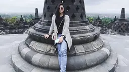 Saat dirinya tengah berlibur di Candi Borobudur, Eriska pun memilih menggunakan penampilan santai dengan celana denim serta baju berwarna hitam. Penampilan tersebut ia padukan dengan cardigan serta sebuah sling bag mini dan kacamata. (Liputan6.com/IG/@eriskarein)