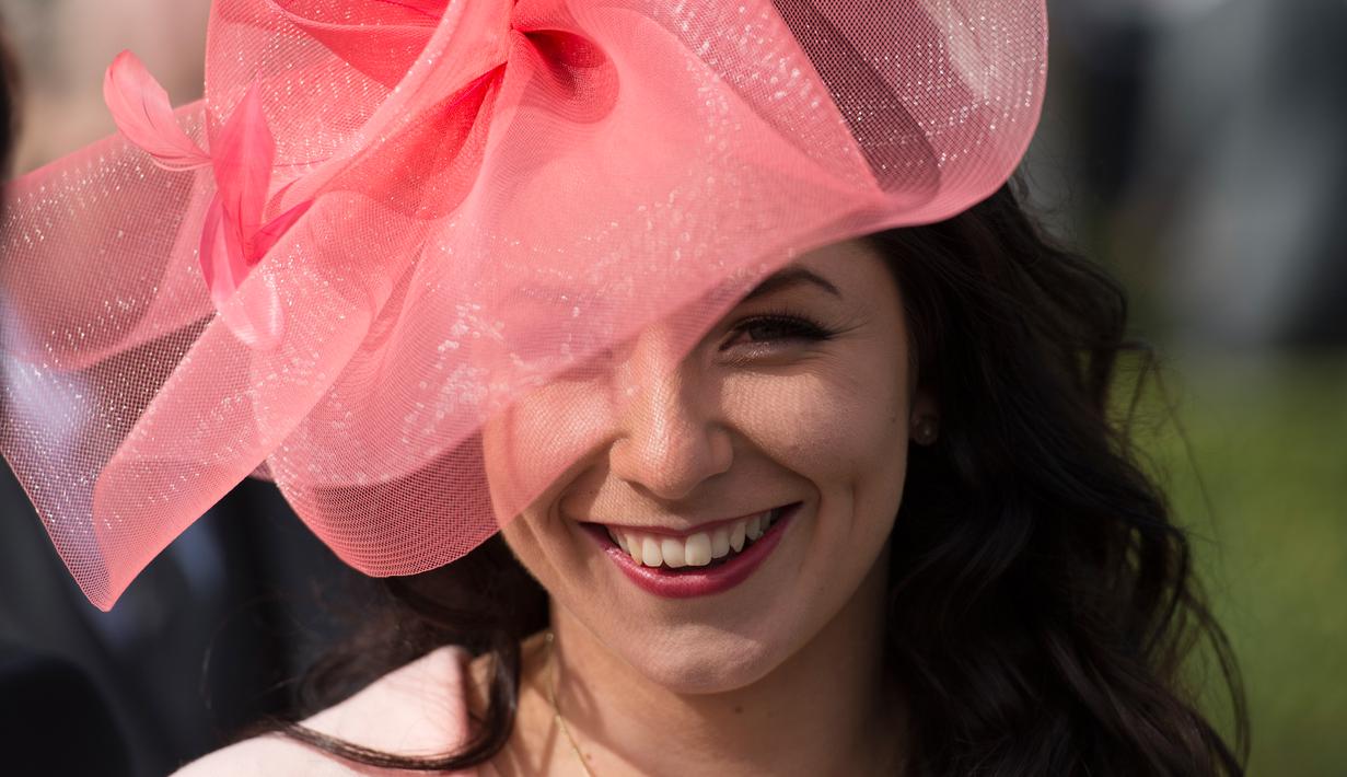 Seorang wanita penggemar balap kuda menghadiri pembukaan pacuan kuda Aintree di Liverpool, Inggris, Kamis (7/4/2016). Acara yang digelar setiap tahun ini dihadiri para bangsawan dan kaum menengah. (Oli SCARFF/AFP)