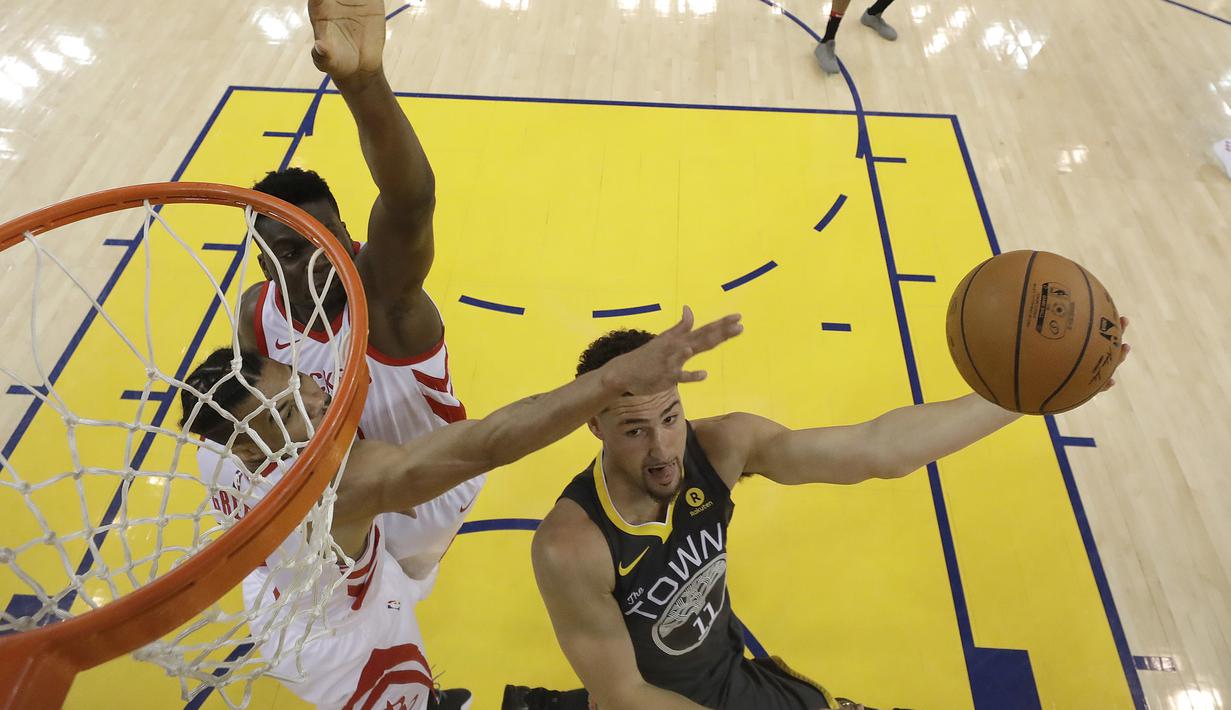 Pemain Warriors, Klay Thompson (kanan) berusaha melakukan tembakan saat diadang pemain Rockets pada gim keempat final NBA basketball Wilayah Barat di Oracle Arena, Oakland (22/5/2018). Rockets menang 95-92. (AP/Marcio Jose Sanchez)