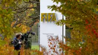 A cameraman stands in front of FIFA's headquarters in Zurich, Switzerland October 8, 2015. FIFA President Sepp Blatter and his possible successor, UEFA chief Michel Platini, have been provisionally suspended for 90 days by the global soccer body's ethics 
