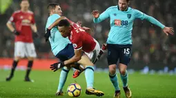 Striker Manchester United, Anthony Martial, terjatuh saat berebut bola dengan gelandang AFC Bournemouth, Brad Smith, pada laga Premier League di Stadion Old Trafford, Rabu(13/12/2017). Manchester United menang 1-0 atas AFC Bournemouth. (AP/Oli Scarff)