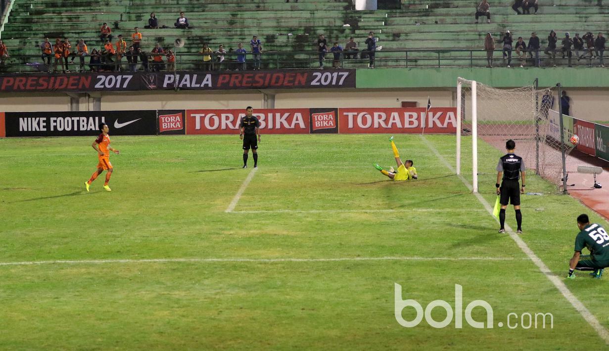 Kiper Madura United gagal menghalau bola sepakan pemain Pusamania Borneo FC saat adu penalti pada babak delapan besar Piala Presiden 2017 di Stadion Manahan, Solo. Jumat (25/2/2017). (Bola.com/Nicklas Hanoatubun)