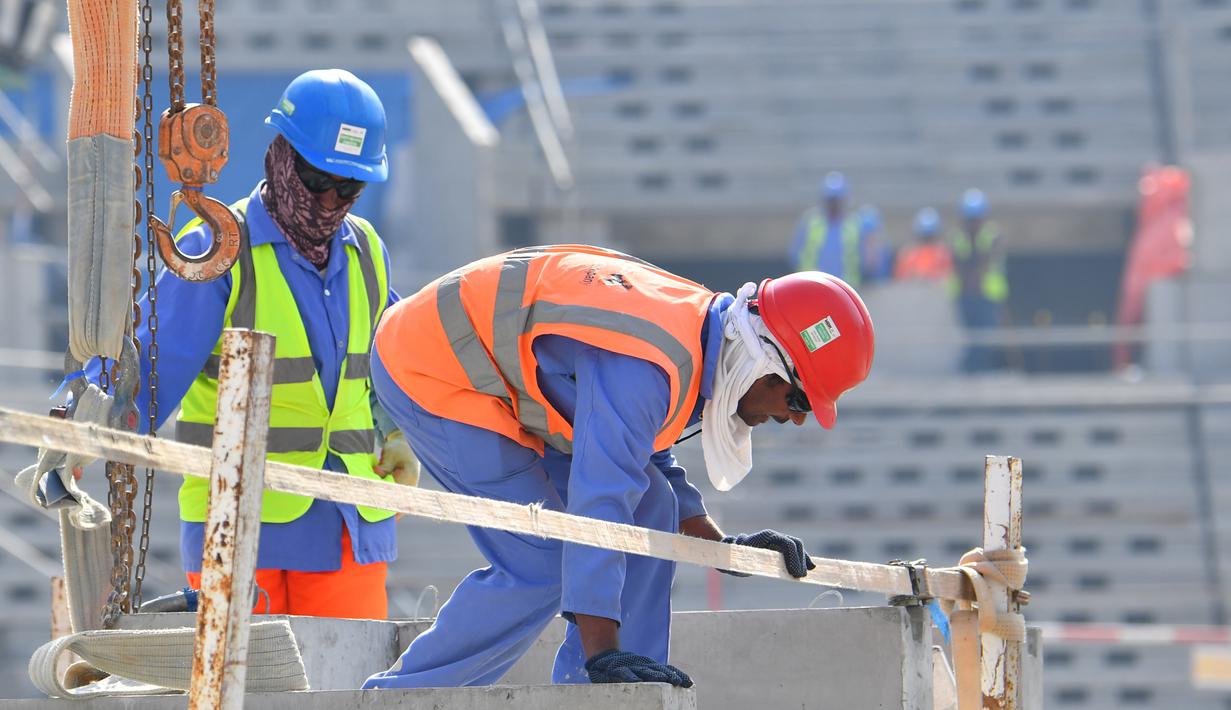 Pekerja menyelesaikan pembangunan Stadion Lusail di Qatar, Jumat (20/12). Lusail akan menjadi stadion untuk partai pembuka dan penutup piala dunia 2022 di Qatar. (AFP/Giuseppe Cacace)
