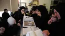 Tidak hanya Amal Khalil, serangan udara Israel di Kota al-Tayri, Lebanon Selatan, juga menewaskan sedikitnya lima orang. Tampak dalam foto, para pelayat berkumpul di sekitar peti jenazah jurnalis Lebanon Amal Khalil yang tewas dalam serangan udara Israel pada Rabu 22 April 2026, memegang koran yang menampilkan potret saudara perempuannya, menjelang prosesi pemakamannya di desa Baysariyeh, Lebanon Selatan, Kamis, 23 April 2026. (AP Photo/Mohammed Zaatari)