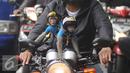 Dua ekor monyet lengkap mengenakan pakaian dan helm diatas motor yang kendarai pemiliknya terlihat di kawasan Senayan, Jakarta, Kamis (1/12). Monyet Ekor Panjang atau Monyet Pantai ini memang menjadi hewan peliharaan exotis. (Liputan6.com/Helmi Affandi)