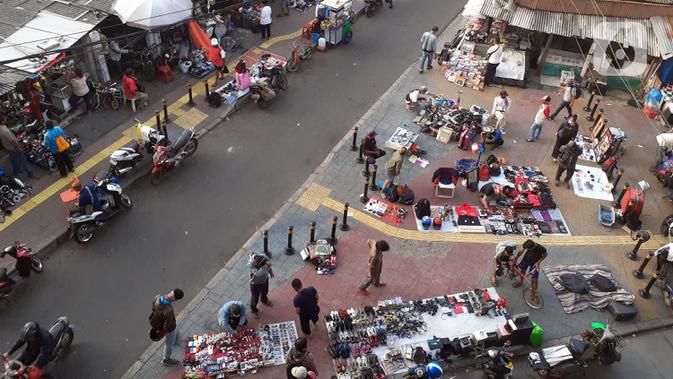 Pedagang kaki lima menjajakan dagangannya di trotoar kawasan Kebayoran Lama, Jakarta, Jumat (15/5/2020). Kondisi ini menyulitkan pejalan kaki yang akan melintasi trotoar di kawasan tersebut. (Liputan6.com/Helmi Fithriansyah)