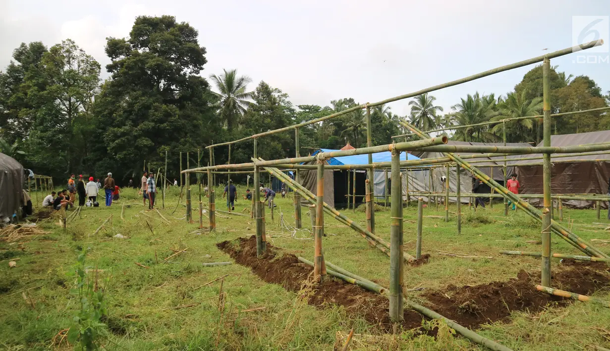 Warga membangun kamp pengungsian Gunung Agung di lahan milik dinas pertanian, Karangasem, Bali, Senin (27/11). Status Gunung Agung yang naik dari siaga ke awas, membuat warga diminta mengungsi dari radius 8 hingga 10 kilometer. (Liputan6.com/Andi Jatmiko)