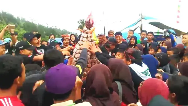 Warga Banyumas berebut gunungan gula memperingati hari bumi sedunia. (Foto: Liputan6.com/Muhamad Ridlo)