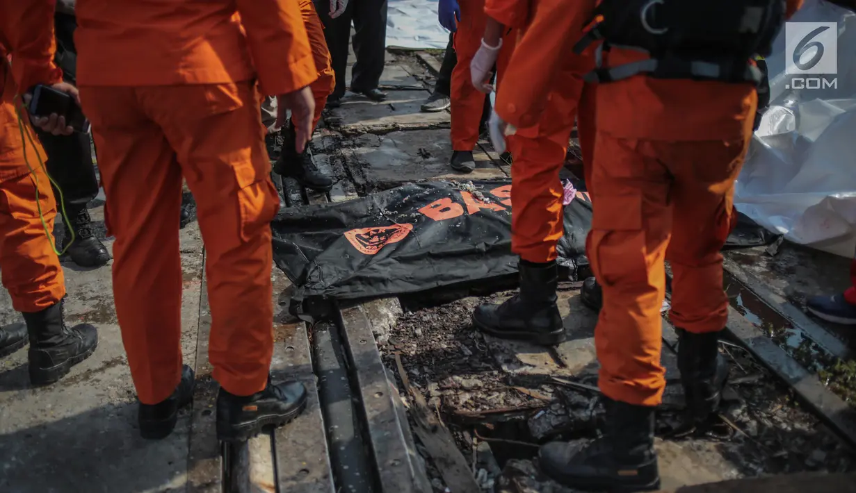Petugas Basarnas menurunkan kantung jenazah terkait jatuhnya pesawat Lion Air JT 610 di Posko Evakuasi, Tanjung Priok, Jakarta, Senin (29/10). Pesawat Lion Air JT 610  yang jatuh di Karawang buatan tahun 2018. (Liputan6.com/Faizal Fanani)