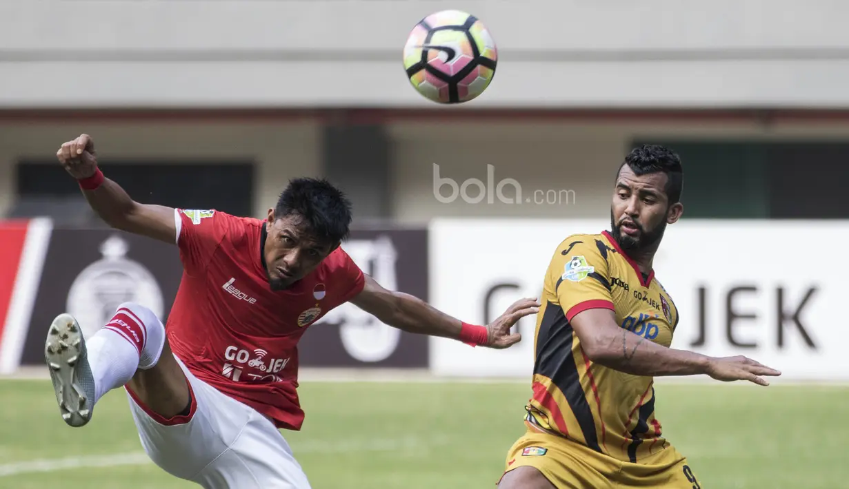 Bek Persija, Maman Abdulrahman, membuang bola dari jangkauan striker Mitra Kukar, Marclei, pada laga Liga 1 di Stadion Patriot, Bekasi, Minggu (14/5/2017). Kedua tim bermain imbang 1-1. (Bola.com/Vitalis Yogi Trisna)