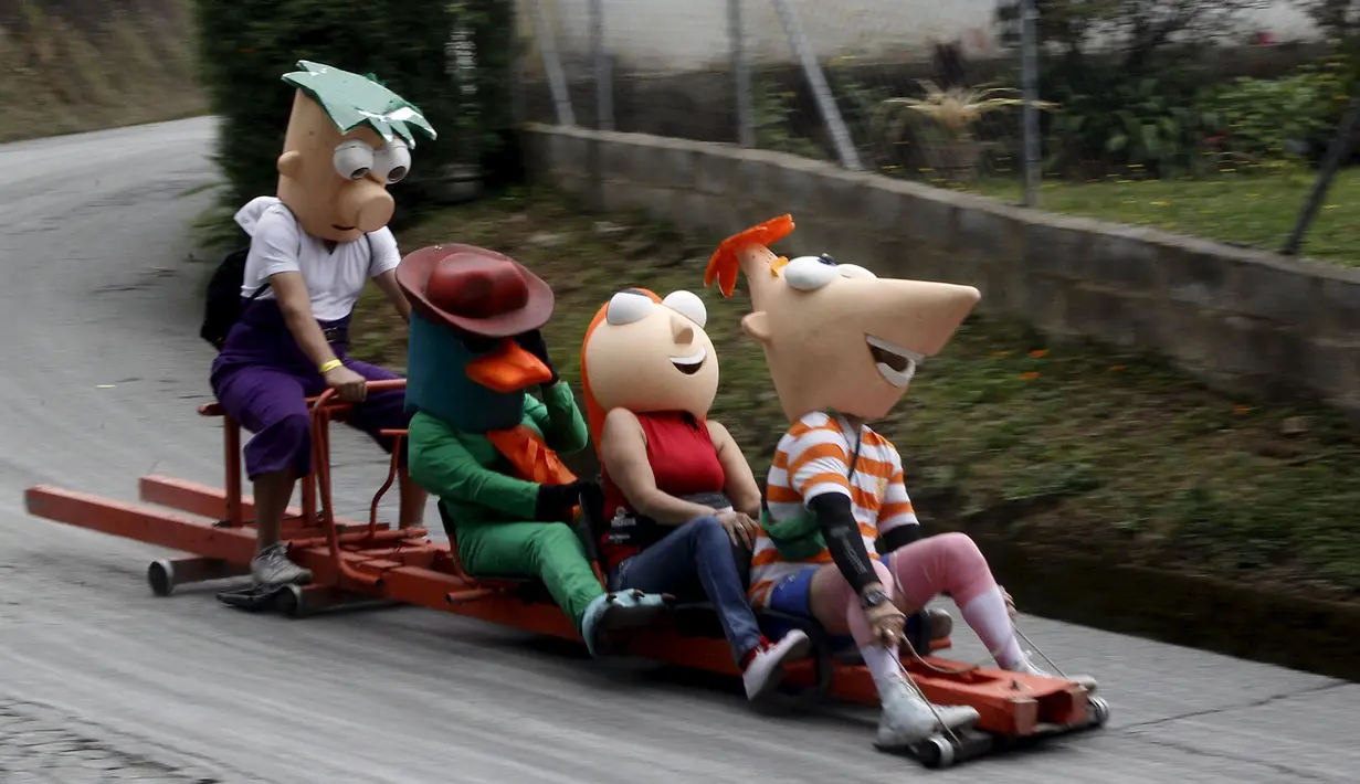   Sejumlah peserta mengenakan kostum – kostum unik saat mengikuti festival Roller Cart ke-26 di Medellin ,Kolombia, Senin (6/9/2015). Peserta saling berlomba menjadi yang tercepat dalam menuruni bukit. (REUTERS/Fredy Builes)
