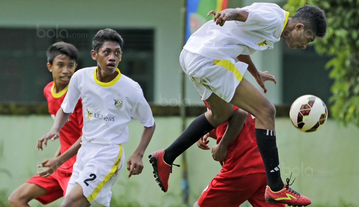 Pemain SSB Galunggung berusaha menyundul bola saat melawan SSB Rumah Tiga pada laga Liga Remaja UC News di Lapangan Masariku Yonif 733, Ambon, Selasa (28/11/2017). SSB Galunggung menang 5-0 atas SSB Rumah Tiga. (Bola.com/Peksi Cahyo)