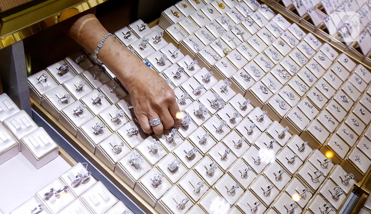 Pramuniaga merapikan perhiasan di sela-sela pembukaan New Jewellery Center di Gajah Mada Plaza, Jakarta, Senin (18/04/2022). Konsep mewah di New Jewellery Center akan mendukung konsep baru Gajah Mada Plaza yang tampil modern dengan dominasi warna gold dan brown. (Liputan6.com/Fery Pradolo)