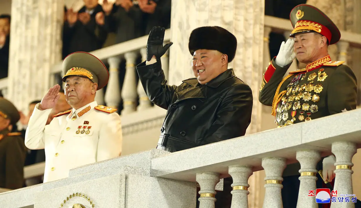 Pemimpin Korea Utara Kim Jong-un melambaikan tangan saat menghadiri parade militer menandai kongres partai yang berkuasa di Lapangan Kim Il-sung, Pyongyang, Korea Utara, Kamis (14/1/2021). (Korean Central News Agency/Korea News Service via AP)