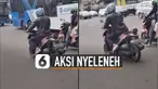 Pria itu nampak tidak mau memijakkan kakinya di aspal jalan.