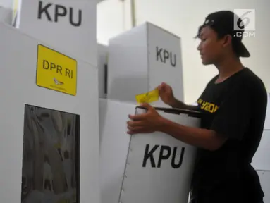 Pekerja menempel stiker khusus kotak suara DPR RI usai perakitan kotak suara di gudang, Jalan Arteri Yos Sudarso Semarang, Selasa (12/2). Sebanyak 22.670 kotak suara dirakit yang dikerjakan oleh 20 pekerja dalam waktu satu bulan. (Liputan6.com/Gholib)