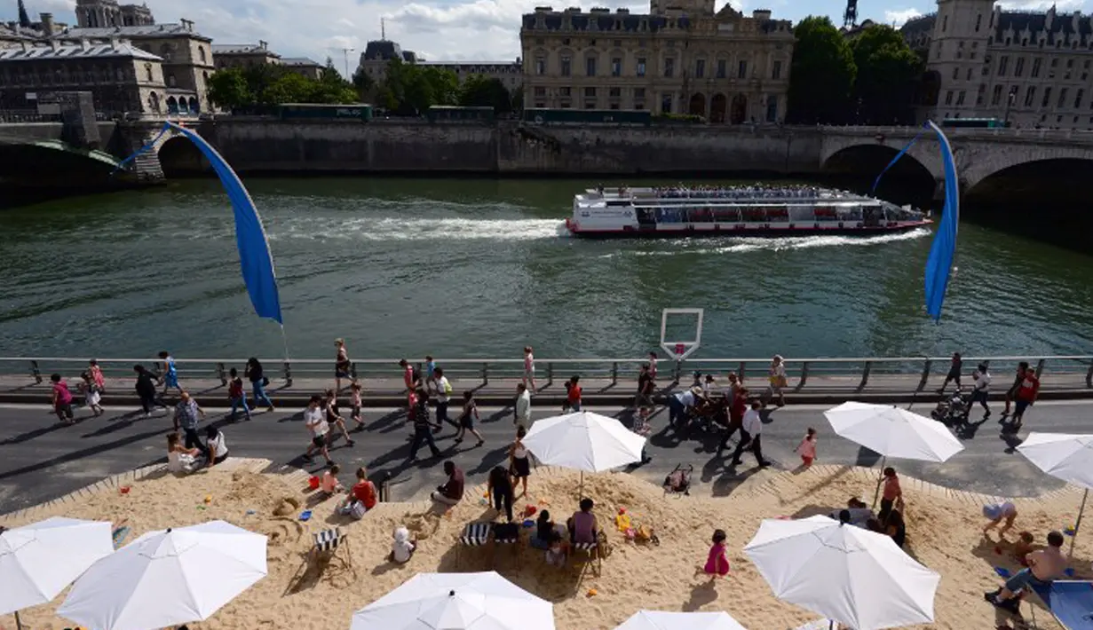 Di pantai buatan ini, traveler bisa melakukan berbagai aktivitas layaknya pantai sungguhan, Perancis, Rabu (22/7/2015).  Tahun ini adalah edisi ke-14 dari Paris Plages, acara budaya dan wisata utama di Paris selama musim panas. (AFP Photo/Miguel Medina)