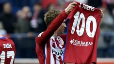Pemain Atletico Madrid, Fernando Torres mengangkat baju bertuliskan 100 gol yang telah dicetaknya bersama Atletico Madrid pada Lanjutan La Liga Spanyol di Stadion Vicente Calderon, Sabtu (6/2/2016).  (EPA/Javier Lizon)