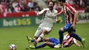 Pemain Real Madrid, Isco (tengah) saat di adang para pemain Sporting de Gijon pada lanjutan La Liga di El Molinon Stadium, Gijon,(15/42017). Real Madrid menang 3-2. (AP/Alvaro Barrientos)