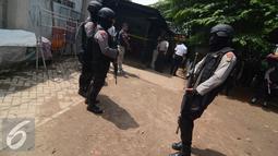 Petugas kepolisian dari Densus 88 berjaga yang diduga markas teroris di Tangerang Selatan, Banten, Kamis (28/1/2016). Penggeledahan ini merupakan pengembangan dari penangkapan terduga teroris berinisial K dan M. (Liputan6.com/Faisal R Syam)
