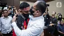 Terdakwa kasus penganiayaan kepada Cristalino David Ozora, Mario Dandy Satriyo memeluk Rafael Alun Trisambodo yang menjadi terdakwa pada kasus dugaan gratifikasi dan tindak pidana pencucian uang (TPPU) sesaat sebelum mengikuti sidang lanjutan di Pengadilan Tipikor, Jakarta, Senin (6/11/2023). (Liputan6.com/Faizal Fanani)