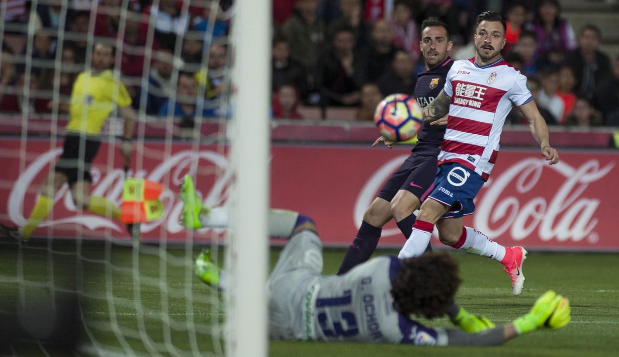 Striker Barcelona, Paco Alcacer, memasukan bola ke gawang Granada. Gol Barcelona dicetak oleh Luis Suarez, Paco Alcacer, bunuh diri Matthieu Saunier dan Neymar sementara Granada hanya mencetak satu gol lewat Jeremie Boga. (AFP/Jorge Guerrero)