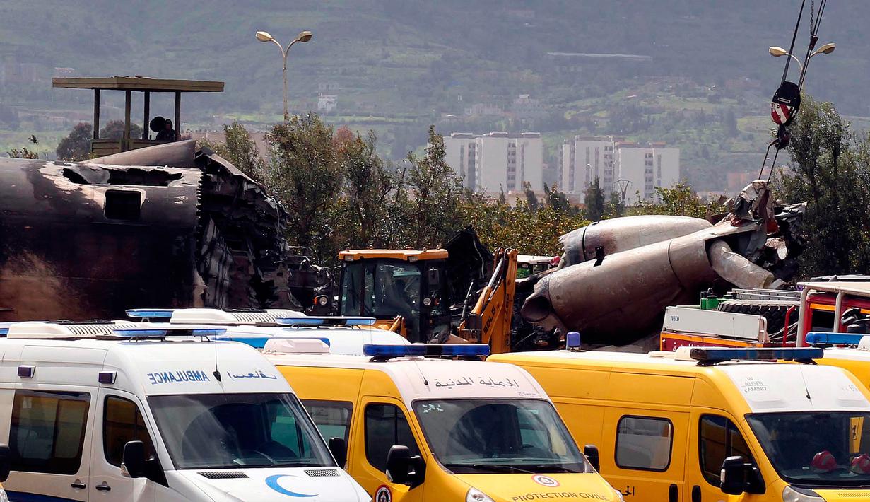 Mobil tim medis dan ambulans berada di dekat reruntuhan pesawat tentara Aljazair yang jatuh di Aljazair (11/4). Pejabat setempat mengatakan pesawat jatuh tak lama setelah lepas landas dari pangkalan udara Boufarik. (AP Photo/Anis Belghoul)