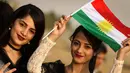 Seorang gadis Kurdi Iran memegang bendera Kurdi saat mengampanyekan referendum untuk kemerdekaan di kota Bahirka, Irak Utara (21/9). Mereka meminta referendum untuk menentukan kemerdekaan etnis Kurdi di Irak. (AFP Photo/Safin Hamed)