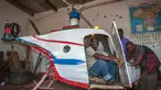 Felix Kambwiri duduk di kokpit helikopter buatannya di garasi rumahnya di Desa Gobede, Malawi, 19 Februari 2016. Helikopter yang dikerjakan sejak empat bulan lalu itu dibuat dari rongsokan besi tua dan fiberglass. (Amos Gumulira/AFP)