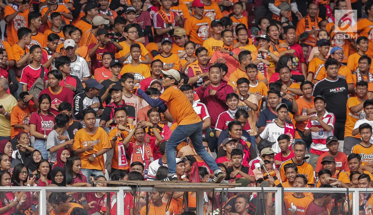 Suporter Persija, The Jakmania manari untuk memberi dukungan kepada tim kesayangan mereka saat menghadapi Persib dalam laga pekan kedelapan Shopee Liga 1 2019 di SUGBK, Jakarta, Rabu (10/7/2019). Pendukung Persib, Bobotoh, dilarang datang ke SUGBK. (Liputan6.com/Faizal Fanani)