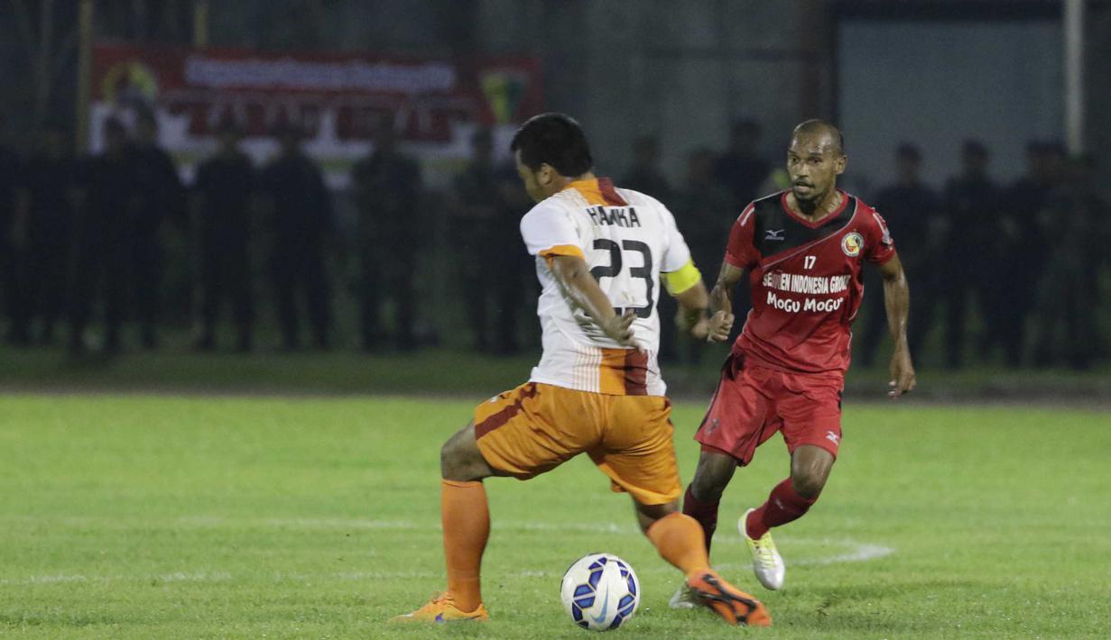 Striker Semen Padang, Nur Iskandar, melewati bek PBFC, Hamka Hamzah, pada laga semifinal Piala Jenderal Sudirman di Stadion Stadion Haji Agus Salim, Padang, Sabtu (16/1/2016). (Bola.com/Reza Bachtiar)