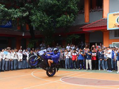 Pembalap rookie Prima Pramac Racing, Toprak Razgatlioglu, melakukan aksi freestyle saat mengunjungi SMK Negeri 39 Jakarta di kawasan Cempaka Putih, Jakarta Pusat, Selasa (20/1/2026). (Bola.com/M Iqbal Ichsan)
