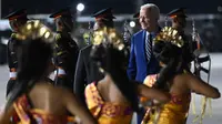 Presiden Amerika Serikat (AS) Joe Biden disambut oleh tarian khas Bali saat turun dari pesawat kepresidenan AS, Air Force One setibanya di Bandara I Gusti Ngurah Rai Bali, Minggu (13/11/2022). Kehadiran Joe Biden untuk menghadiri Konferensi Tingkat Tinggi (KTT) G20 di Bali yang akan digelar pada 15-16 November 2022. (SAUL LOEB / AFP)