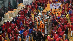 Sekelompok warga turut ambil bagian dalam perang jeruk yang diselenggarakan selama Karnaval Ivrea di Turin, Italia (16/2). (AFP PHOTO/Olivier MORIN)