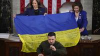 Presiden Ukraina Volodymyr Zelensky berpidato di pertemuan gabungan Kongres di Capitol Hill di Washington, Rabu, 21 Desember 2022. Ia menyerahkan bendera Ukraina yang ditandatangani oleh pasukan garis depan di Bakhmut. (AP Photo/Jacquelyn Martin)