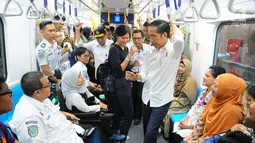 Presiden Joko Widodo berbincang dengan penyandang disabilitas saat menjajal MRT di Jakarta, Kamis (21/3). Jokowi didampingi Ibu Negara Iriana mencoba kembali kereta tersebut bersama disabilitas, dan artis Chelsea Islan. (Liputan6.com/Angga Yuniar)