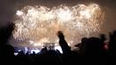 Warga menikmati pertunjukan Tahun Baru di Kim Il-sung Square, Pyongyang, Korea Utara, Sabtu (1/1/2022). Ratusan orang di Pyongyang berkumpul dengan mengenakan masker untuk menyaksikan pertunjukan kembang api menyambut Tahun Baru 2022. (AP Photo/Jon Chol Jin)