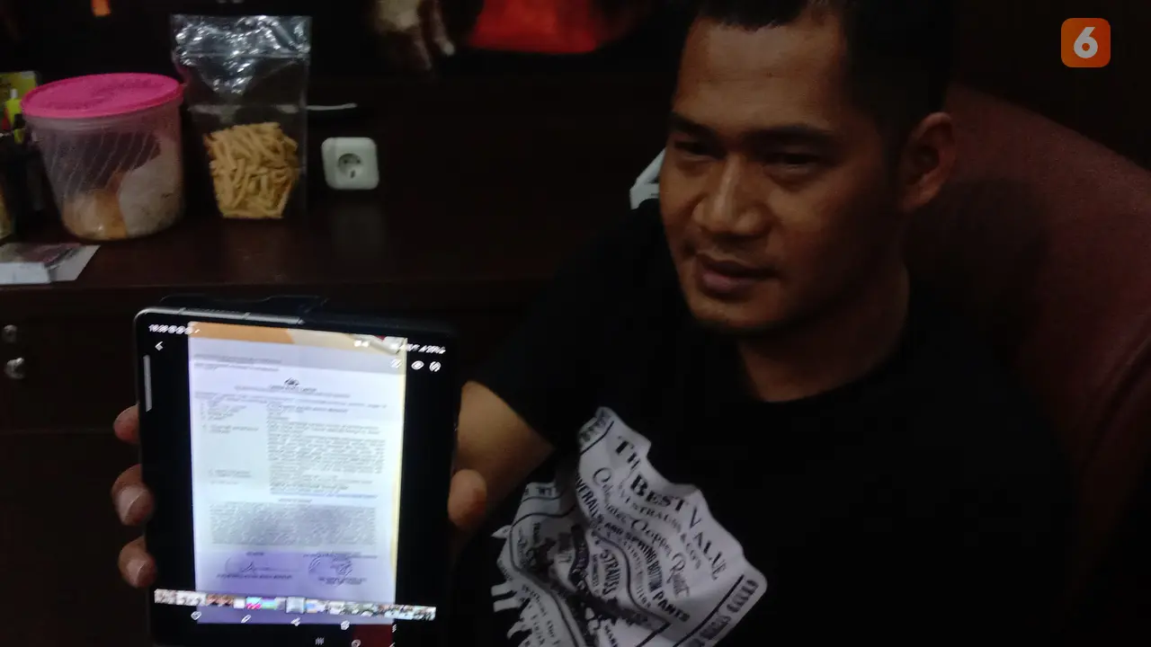 Pujiyanto Menunjukkan Surat Laporan Indra Tarigan Ke Polda Banten. (Rabu, 30/11/2022). (Yandhi Deslatama/Liputan6.com).