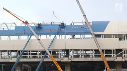 Pekerja menyelesaikan pembangunan stasiun LRT di kawasan Ciracas, Jakarta, Sabtu (23/3). Pada tahun 2019, pemerintah menganggarkan dana APBN untuk infrastruktur sebesar Rp415 triliun, naik 1,04% dari anggaran infrastruktur tahun sebelumnya. (Liputan6.com/Immanuel Antonius)