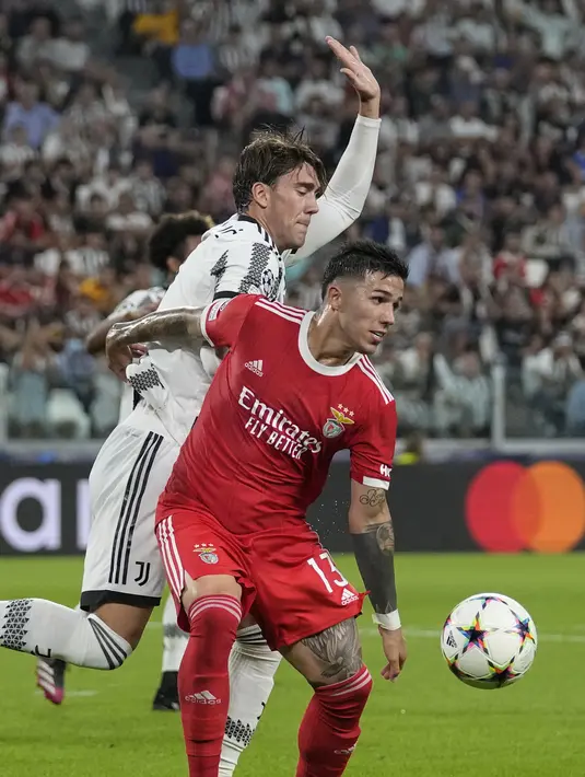 Gelandang Benfica Enzo Fernandez berebut bola dengan penyerang Juventus Dusan Vlahovic dalam duel matchday 2 Grup H Liga Champions 2022/2023 di Allianz Stadium, Kamis (15/9/2022) dini hari WIB. Juventus dipermalukan tamunya Benfica dengan skor 1-2. (AP Photo/Antonio Calanni)